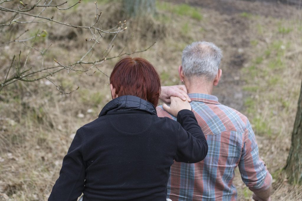 Caregiver assisting elderly man