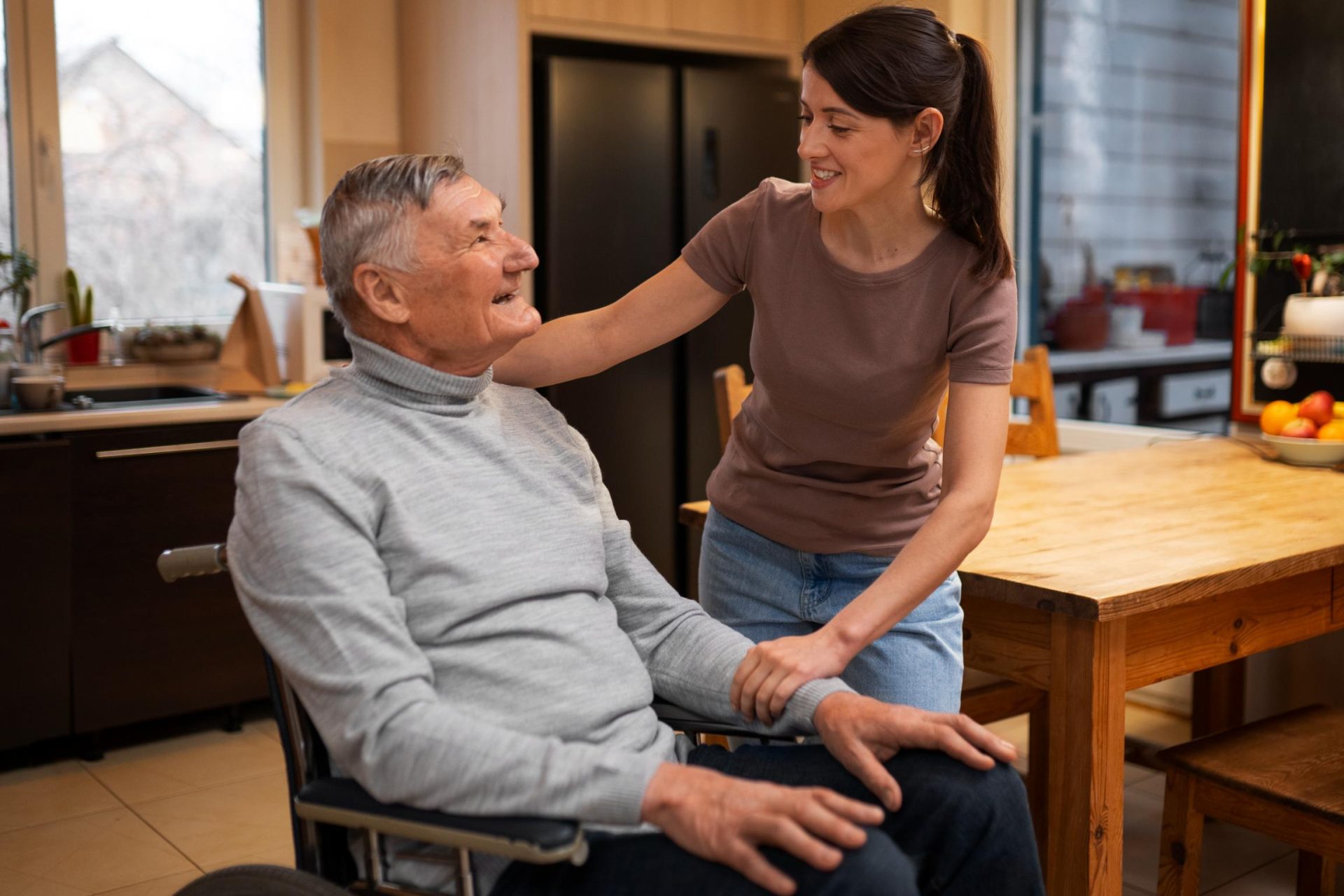 Woman supports smiling elderly man