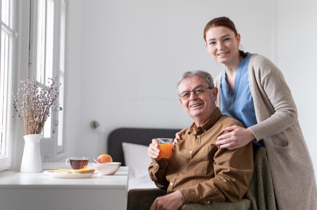 Caregiver assisting elderly man