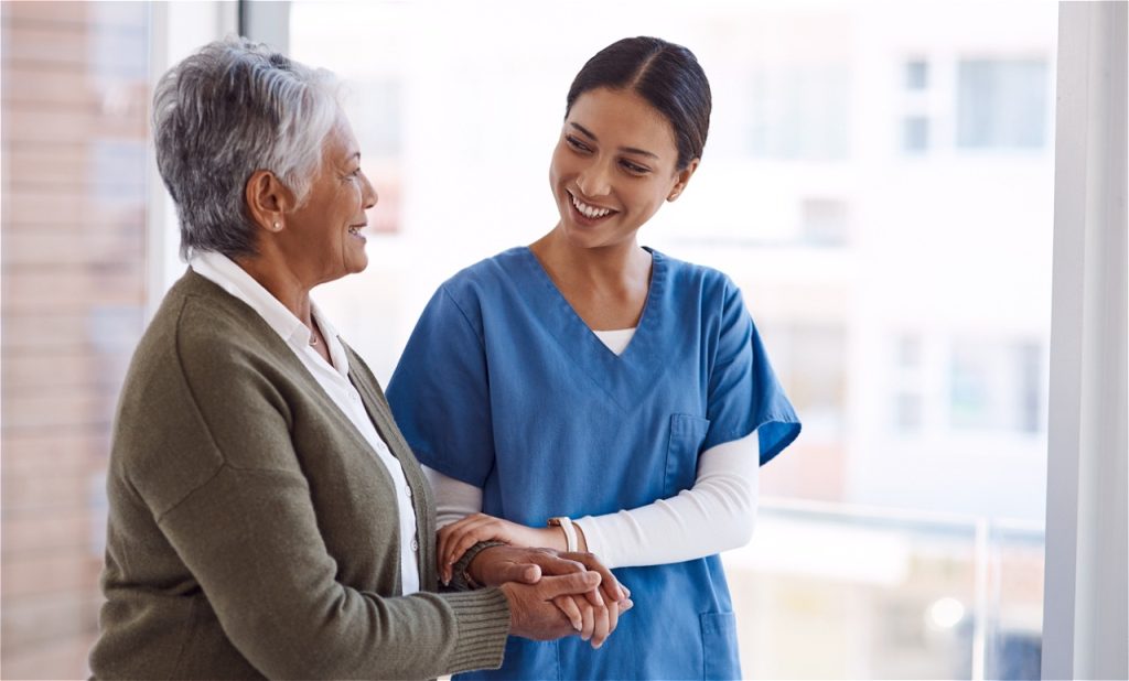 Nurse assisting an elderly woman